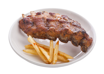 Grilled juicy barbecue pork ribs in a white plate with fries
