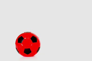 Fototapeta premium Red soccer ball alternating black on a white background.