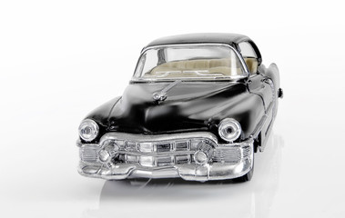 The front view on model of the classical American car of black color.