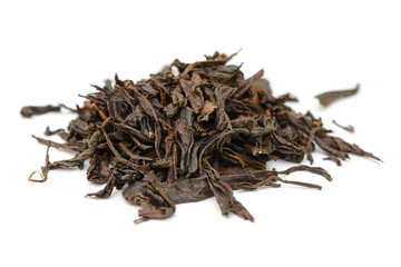 bunch of black tea leaves on a white background