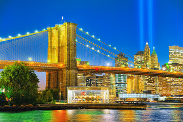 Naklejka na ściany i meble New York night view of the Lower Manhattan and the Brooklyn Bridge across the East River.