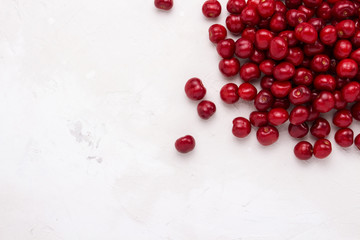 Fresh cherry on a light stone background. Concept of harvest. Flat lay, top view