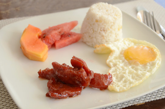 A hearty Filipino breakfast typically consists of meat, sinangag (garlic fried rice), and itlog (egg). A plate including tocino (sweet cured pork) is called tocilog.