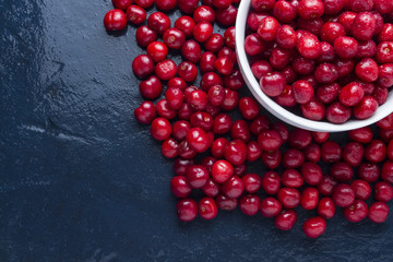 Freshly picked cherry with drops of dew and water in a white bowl. Concept of harvest. Flat lay, top view