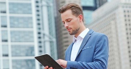 Fototapeta premium Businessman work on tablet computer in city