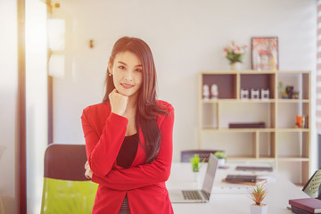 Portrait of successful businesswoman standing at her office.	