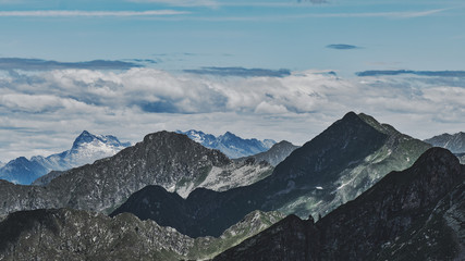 Fototapeta na wymiar Panorama of mountain range with games of shadows and lights