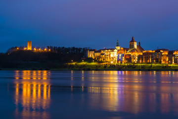 Fototapeta na wymiar A view of Grudziadz at night reflected in Vistula river, Poland. Europe.