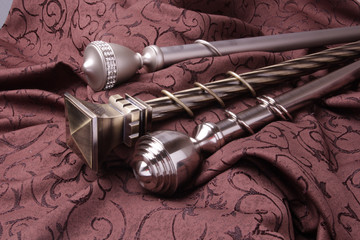 Metal ending for cornices and the folded fabric. Curtain rod and finials on the folded fabric
