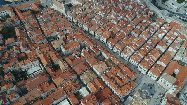 Aerial view shot by a drone of popular main street and rooftops of beautiful historic buildings in Dubrovnik, tourism travel Croatia Europe