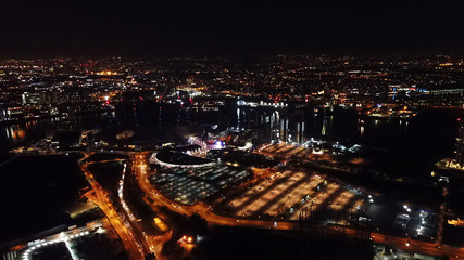 Aerial drone bird's eye view night shot of iconic O2 Arena as seen from Greenwich Peninsula, Isle...