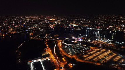 Aerial drone bird's eye view night shot of iconic O2 Arena as seen from Greenwich Peninsula, Isle...