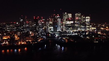 Aerial bird's eye view photo taken by drone of famous Canary Wharf skyscraper complex, Isle of Dogs, London, United Kingdom