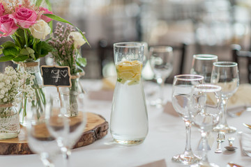 wedding table set up decoration with flowers and glasses