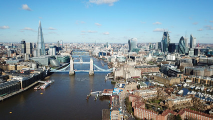 Aerial drone bird's eye view of iconic Tower Bridge, the Shard and skyline in City of London, United Kingdom