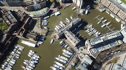 Aerial drone bird's eye view of famous St Katharine Docks Marina and iconic skyline in City of...