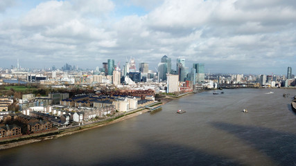 Obraz premium Aerial bird's eye view photo taken by drone of famous Docklands and Canary Wharf skyscraper complex, Isle of Dogs, London, United Kingdom