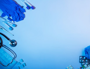 Diagnostic and first aid items, laid out on blue background