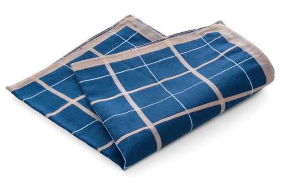 A blue clean handkerchief with a checkered pattern. Napkin thrown, crumpled.