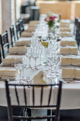 wedding table set up decoration with flowers and glasses