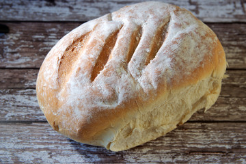 Loaf of bread on wooden board