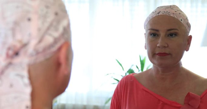 Chemotherapy patient applying make-up