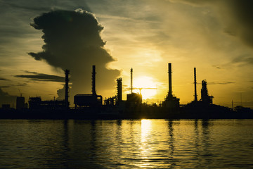 Petrochemical plant On the river During sunrise.