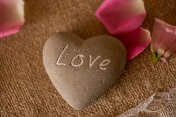 Obraz premium stone in a shape of heart with LOVE engraved 