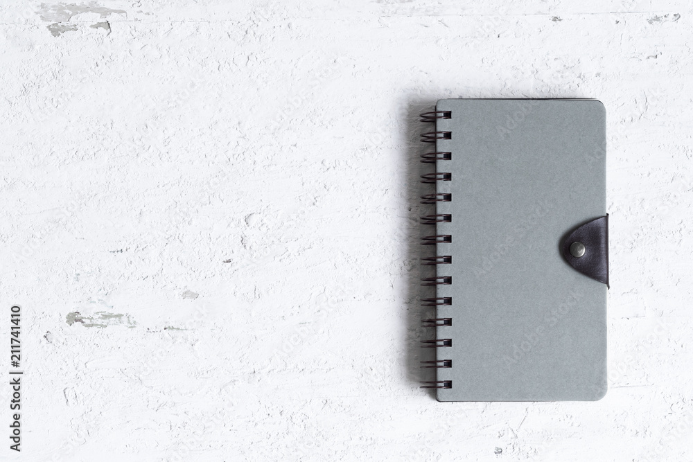 Aufkleber flat lay of closed notebook with blank cover on the rusty white wooden table. view from above with c