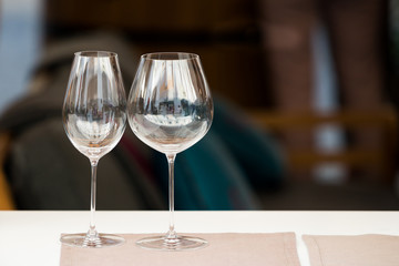 Two empty wine glasses with blurred background