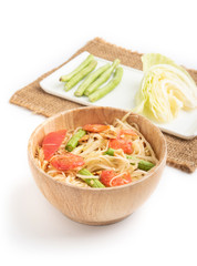 Papaya salad in a wooden bowl on a white background
