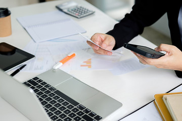 Woman with bills and calculator. Woman using calculator to calculate bills at the table in office....