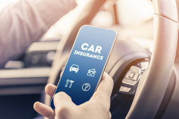  close up of young man hand with smartphone driving car
