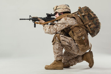 Soldier in camouflage holding rifle