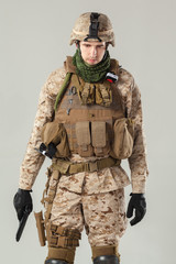 Soldier in camouflage holding rifle