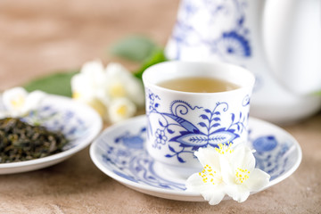 A porcelain cup with green tea with a taste of jasmine.