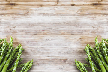 bunch of green asparagus on wooden board with copy space