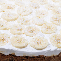 Fototapeta na wymiar Vegan banoffee pie made from oats, dates, bananas and coconut cream, closeup view