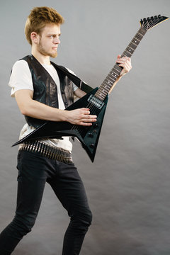 Young man playing electric guitar