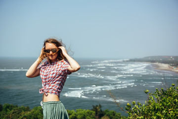 Beautiful girl relaxing on sea rocks