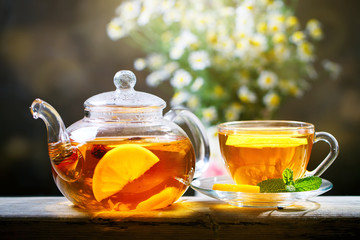 Cup of freshly brewed black tea,warm soft light, darker background.