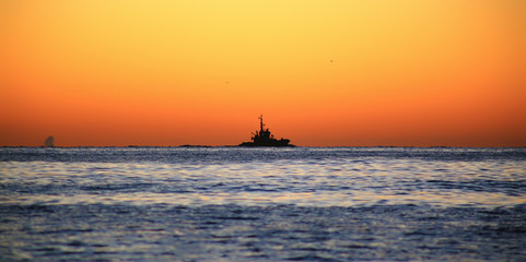 Fishing Boats inan orange sky