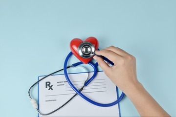 Stethoscope, red heart and prescription on blue background, Heart Check.Concept healthcare.
