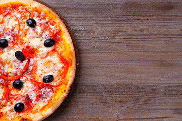 Italian pizza with ham and black olives, delicious appetizing meal. Mediterranean cuisine, restaurant menu, food delivery concept