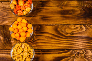 Different snacks for beer on wooden table. Top view