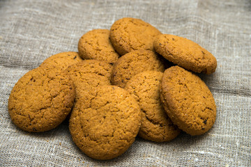 Oats cookies on a gray table in rustic style. seeds on baking. front horizontal view