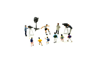 Miniature people : Cameramen, photographers and reporters interviewing football player with...