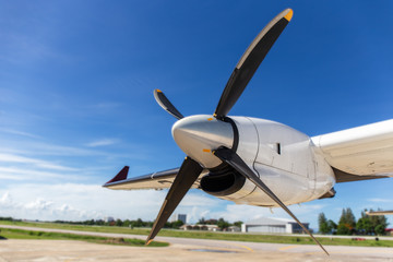 aircraft propeller blade and turboprop engines with airfield and blue sky background