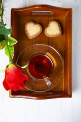 Heart-shaped biscuits, rose and tea