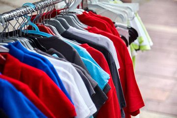 Colorful polo t-shirt for the man on hangers in a retail shop